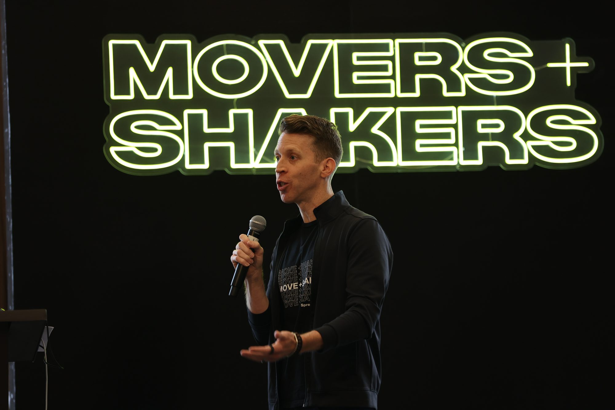 Geoffrey on stage at a Movers+Shakers keynote